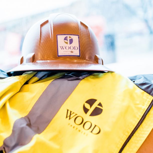 Brown hard hat on top of Wood Partners construction vest