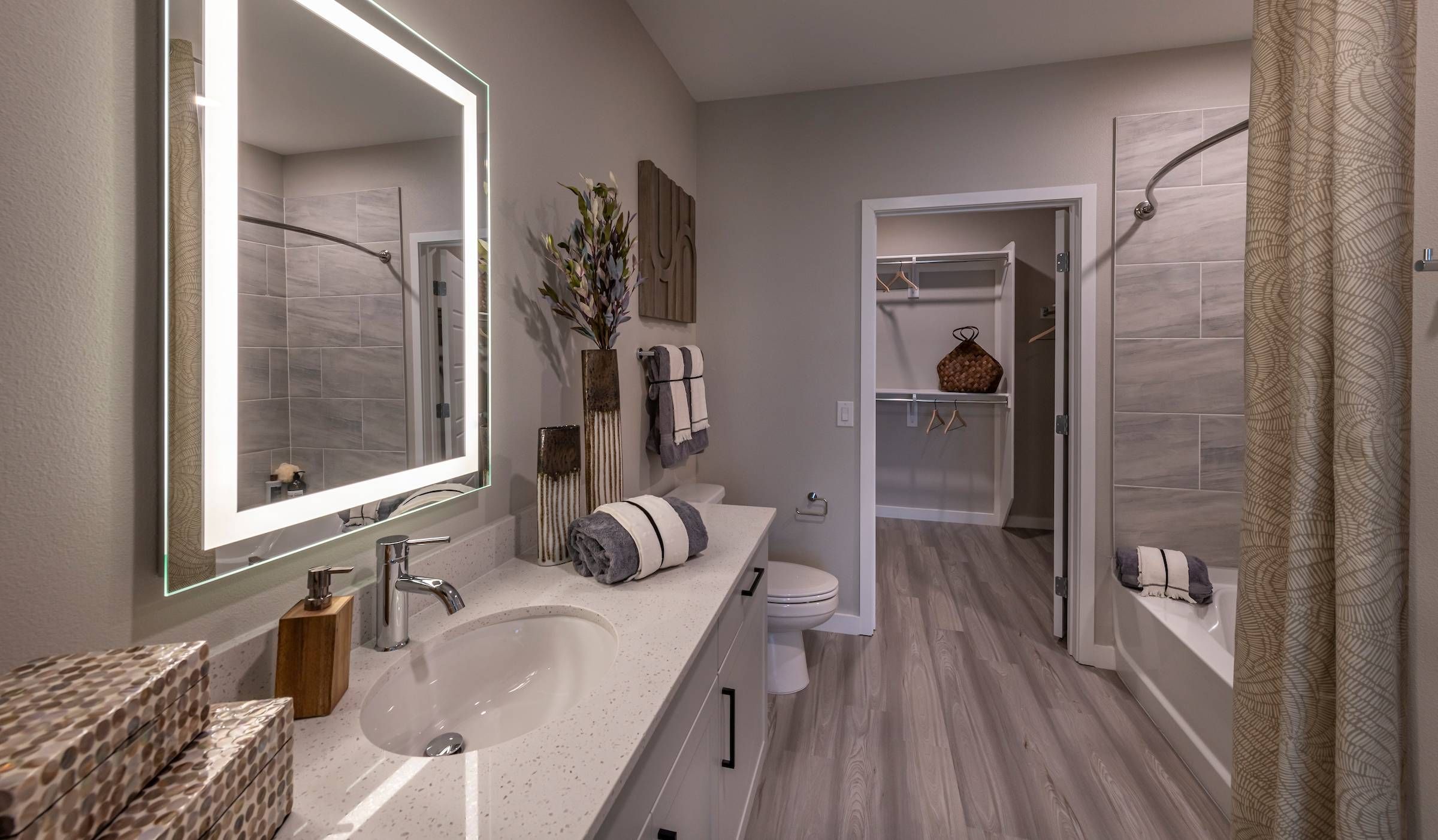 Bathroom in Alta Southern Highlands that showcases a lighted mirror, grey-toned finishes, and a spacious shower.