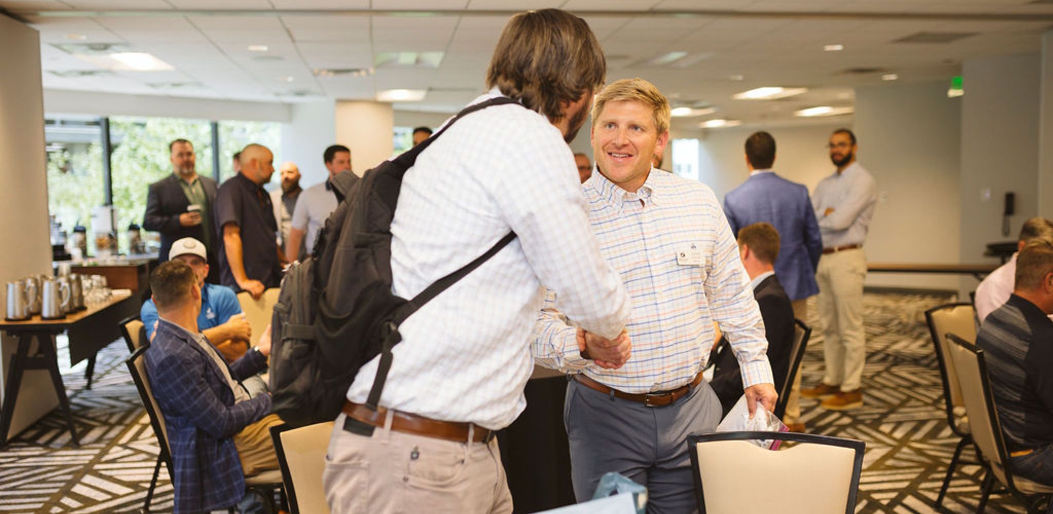 Wood Partners team members shaking hands at conference